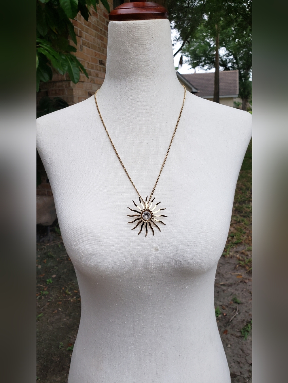 Gold Sunburst Pendant Necklace with Clear Stone